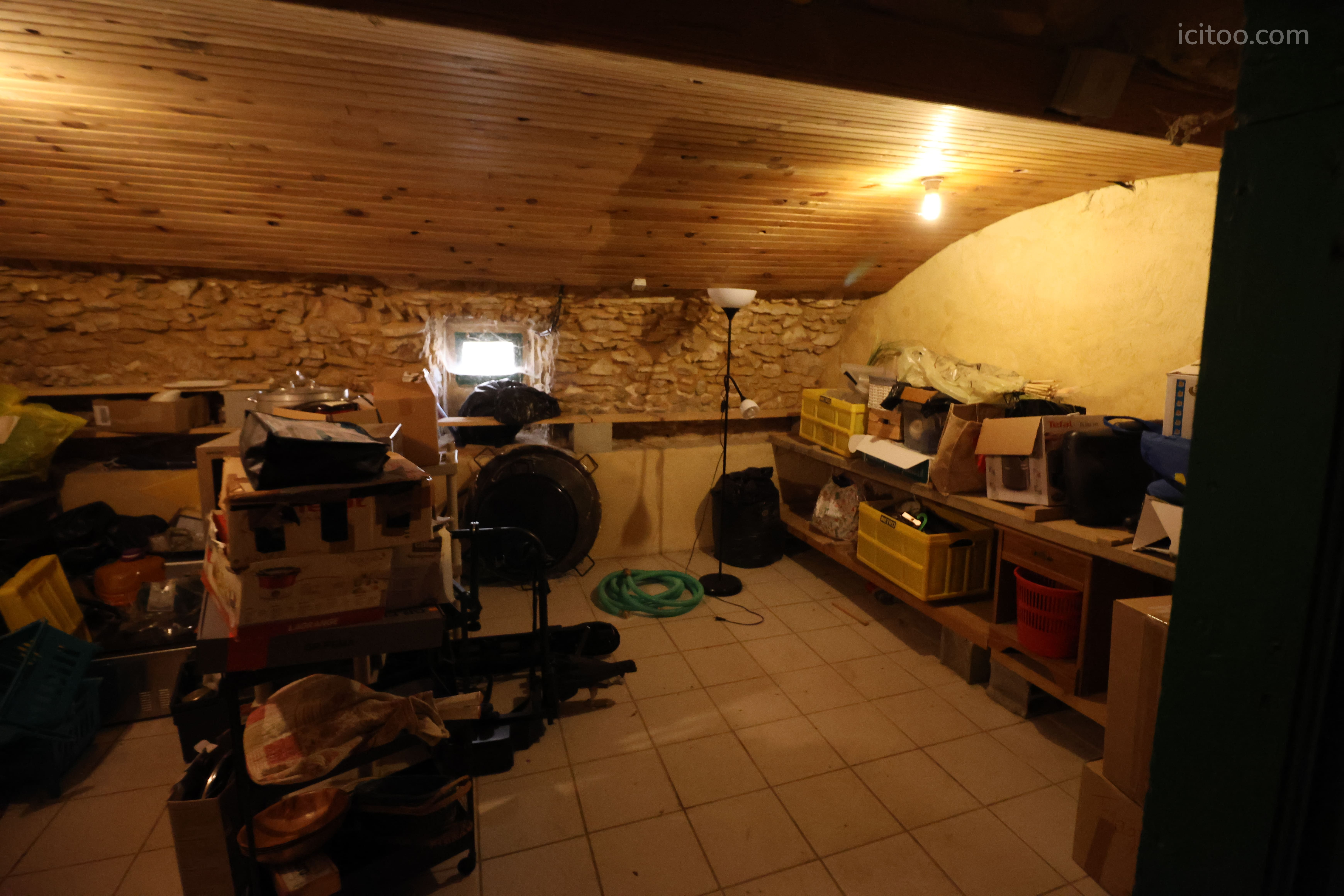 Maison à vendre à Verfeuil : pièce de stockage avec murs en pierre et étagères